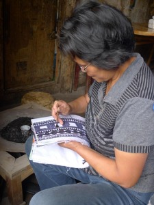 An everyday scene of my village hostess drawing batik. Photo courtesy of Yu Luo.