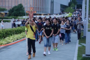 A protester holds up a Christian cross at the Hong Kong Umbrella Movement. Photo courtesy Mariske Westendorp
