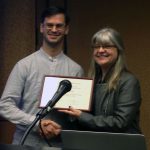 2016 Graduate Paper Prize selection committee chair Carolyn Stevens awards prize to Adam Liebman