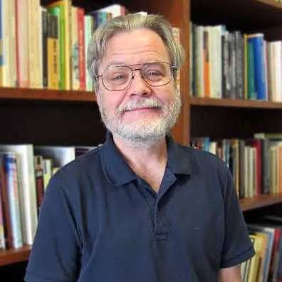 Gordon Mathews in front of bookcase